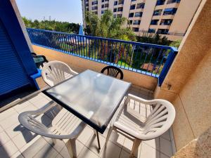 a patio area with a table and chairs at Patacona Resort Apartments in Valencia