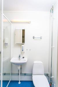 a bathroom with a toilet and a sink at Easy Home Apartments in Hammerfest