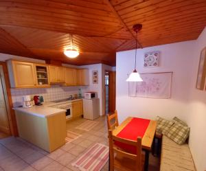 a kitchen with a table and a dining room at Haus Familie Säckl in Altaussee