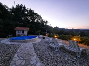 a group of chairs sitting next to a swimming pool at House Mikleus in Lovran