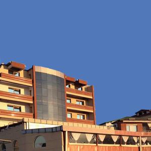 a tall building with windows on the side of it at Hotel Centro Biznis 92 in Vinica