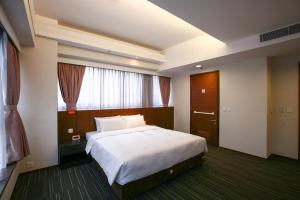 Giường trong phòng chung tại Le Prabelle Hotel