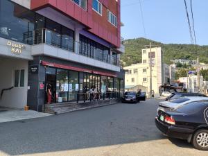 a car parked in front of a building on a street at Ocean View in Geoje 