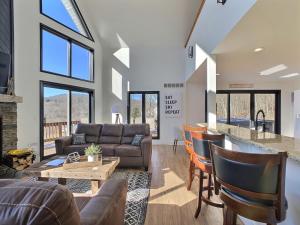 a living room with a couch and a table at The Ridge Chalet in Ellicottville Hot Tub & Sauna in Great Valley