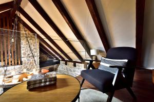 a living room with a chair and a fireplace at Holiday Home Marko in Trilj