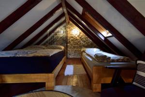 a room with two beds in a attic at Holiday Home Marko in Trilj +55 photos