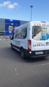 a white van is parked in a parking lot at De`Lore Park Hotel Domodedovo in Domodedovo