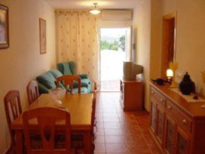 a living room with a table and a couch at Apartamento Cerca de la Playa con wifi in San José +12 photos