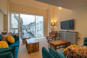 a living room with a couch and a tv at The Warren - Kendal Town Centre, with Parking in Kendal