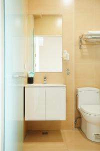 a bathroom with a white sink and a toilet at Miruku Homestay in Taitung City +26 photos
