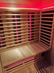 a wooden closet with pink lights on the wall at DBO81 Spacious apartment in the center and beach nearby in Domburg