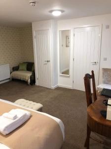 a bedroom with a bed and a desk and a table at JT Abergwaun hotel in Fishguard