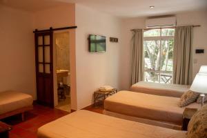 a hotel room with two beds and a window at La Mansa Riverside in Esquina +158 photos