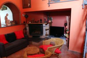 a living room with a couch and a fireplace at Colle Uliveto in Vico Equense