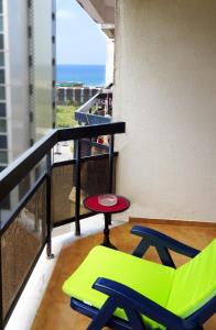 a balcony with two chairs and a table and the ocean at BEACH FLAT COSTA DA CAPARICA in Costa da Caparica