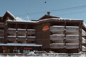 a building with white balconies on it in the snow at Le Val Thorens, a Beaumier hotel in Val Thorens