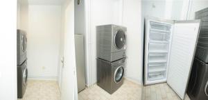 a laundry room with a washing machine and a refrigerator at COSY HOUSE Créteil 3 pièces in Créteil