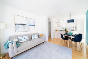 a living room with a couch and a table at Blue by the River 2 - elegant two-bedroom in Santos in Lisbon