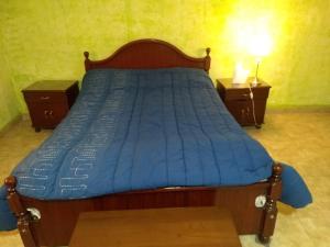 a bed with a blue comforter in a bedroom at Isaac Ush 3 in Ushuaia