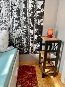 a bedroom with a bed and a side table with a candle at Die kleine Post in Schleiden