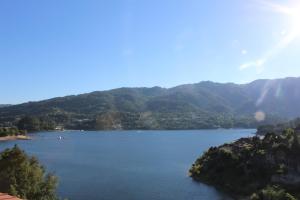 a view of a lake with mountains in the background at Alojamento Por do Sol in Geres