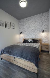 a bedroom with a large bed in a room at Apartament przy Plantach in Nowy Sącz