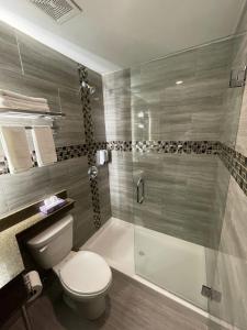 a bathroom with a toilet and a glass shower at Hotel 369 Brooklyn in Brooklyn