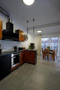 a kitchen with a table and a dining room at Apartament przy Plantach in Nowy Sącz