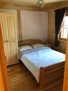 1 dormitorio con 1 cama en una habitación de madera en Vila Milica - Golija, en Radaljica