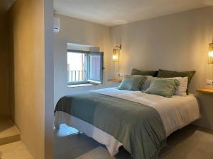 a bedroom with a large bed with a window at CAN SAFRA in La Pera