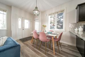 a dining room with a table and chairs at Mediterranean Retreat - King Bed - Fireplace - Garage in Edmonton
