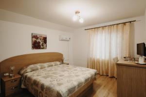 Postel nebo postele na pokoji v ubytování Pensiunea Alin