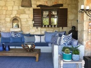 a living room with a blue couch and a table at Lalla Luxury Villa in Lithakia