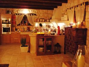 a kitchen with a counter and a woman in the kitchen at Lalla Luxury Villa in Lithakia