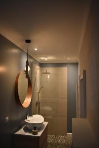 a bathroom with a sink and a shower at Grandparent's House- A small beautiful house in Sibiu