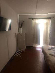 a room with a bed and a window with a curtain at MyRoom sui Portici in Bologna