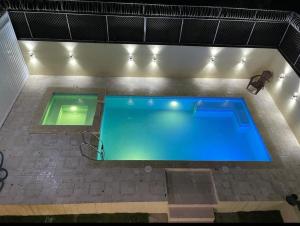 an overhead view of a swimming pool at night at Lomas Hotel in San José de Ocoa