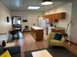 a kitchen and living room with a couch and a table at Stylish ground level apartment close to everything in Rapid City