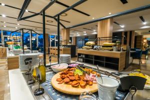a table with a plate of food on a counter at Amulett Wellness Apartman in Siófok
