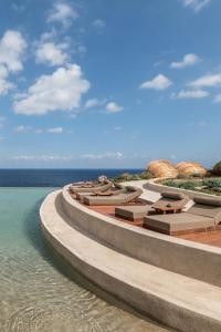 an architectural rendering of a resort with the ocean at Acro Suites - A Wellbeing Resort in Agia Pelagia