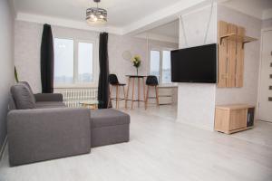 a living room with a couch and a flat screen tv at 2 Rooms Luxury Apartment on Shkilna 34 Street in Zaporozhye