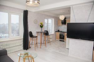 a kitchen and living room with a large flat screen tv at 2 Rooms Luxury Apartment on Shkilna 34 Street in Zaporozhye