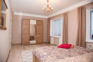 a bedroom with a large bed and a mirror at 2 Rooms Luxury Apartment on Shkilna 34 Street in Zaporozhye