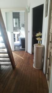 a hallway with a bathroom with a sink and a table at LES PINGOUINS DE LA MARNE in Le Perreux-Sur-Marne