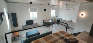 a room with a table and chairs and a kitchen at Prime Fully Equipped Studio 4 Ideal Base to Explore Malta in Il-Furjana