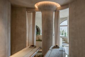 a room with two beds and a large window at Acro Suites - A Wellbeing Resort in Agia Pelagia