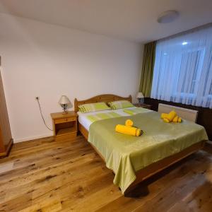 a bedroom with a bed with yellow pillows on it at Ferienwohnung Ausseerland in Bad Aussee
