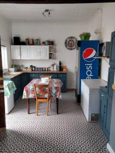 a kitchen with a table with a table cloth on it at Via the Grapevine 3 bedroom house private parking in Colesberg