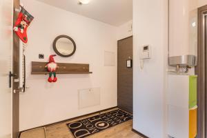 a kitchen with a refrigerator and a mirror on the wall at MAIO Studio Silver Mountain Poiana Brasov in Poiana Brasov +40 photos