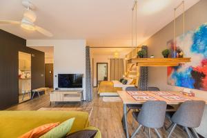 a living room with a dining table and a living room at MAIO Studio Silver Mountain Poiana Brasov in Poiana Brasov